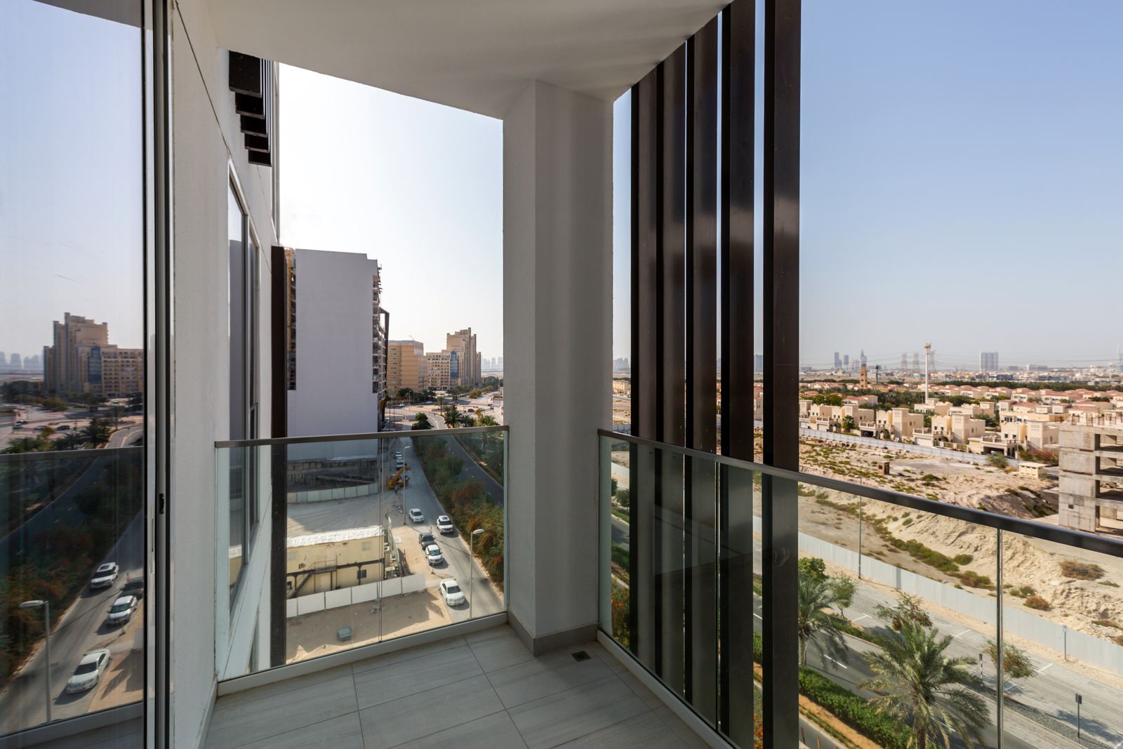 Balcony with glass balustrade and views over JVC
