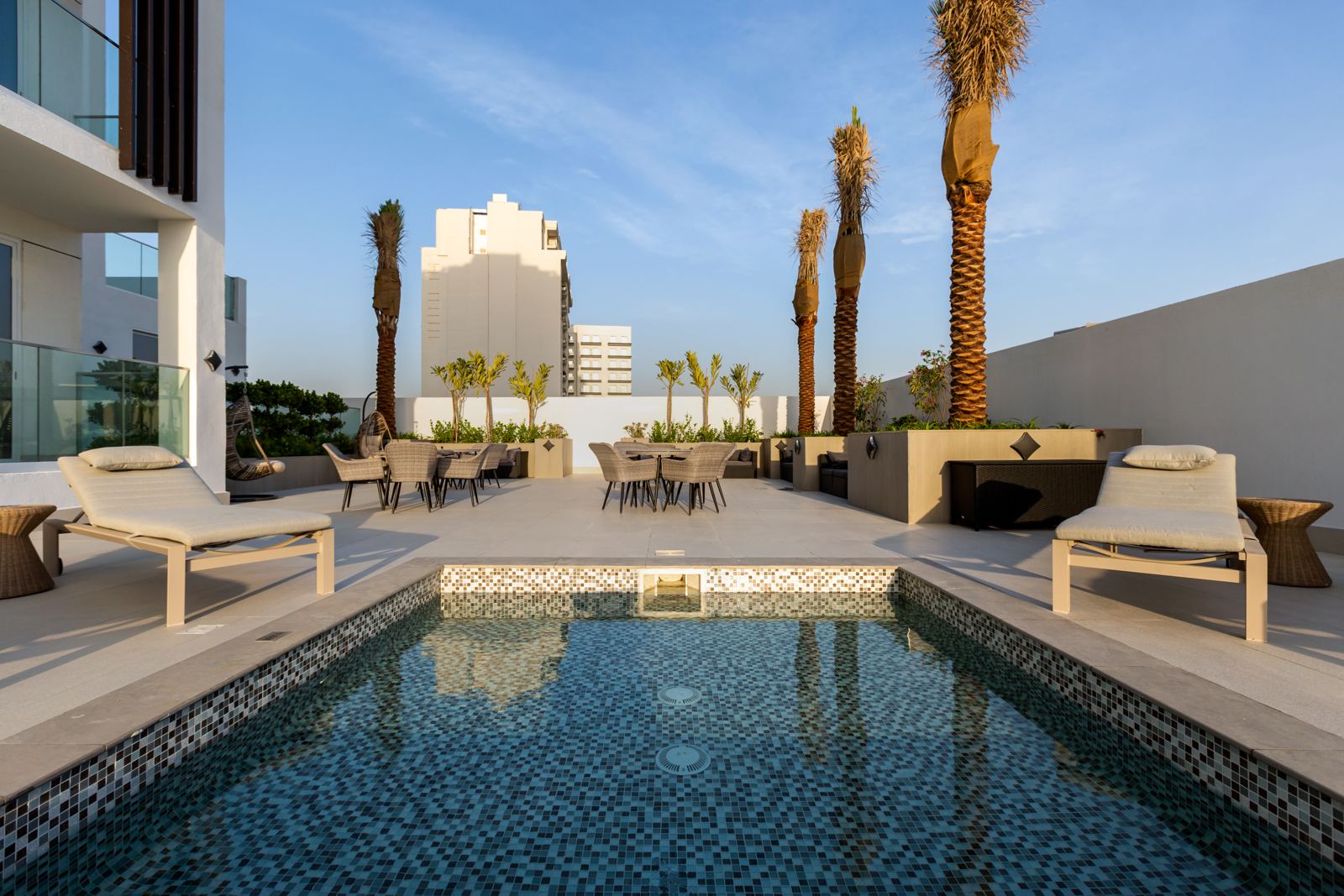 Kids' pool with sun loungers and palm-lined terrace